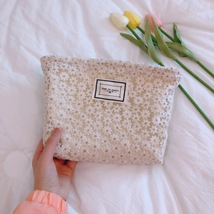 Daisy lace embroidered clutch bag with 'Time to Party' tag on a soft white background