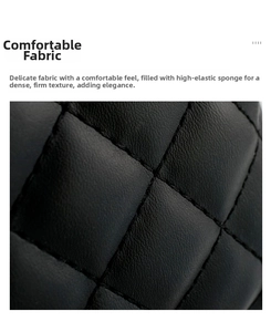 Macro shot of black quilted faux leather fabric with fine stitching and soft texture