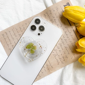 Collapsible heart phone grip featuring real four-leaf clover and gold foil in resin