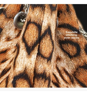 Macro detail of leopard print bag showing high-density stitching and silver metal eyelets