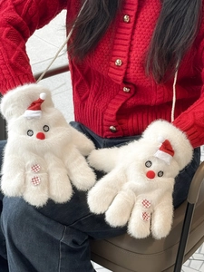 Close-up of white plush snowman mittens with red hats and festive hanging strings