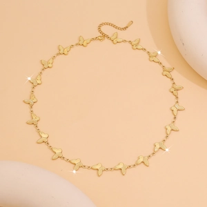 Elegant gold butterfly chain necklace on decorative stone base with lobster clasp