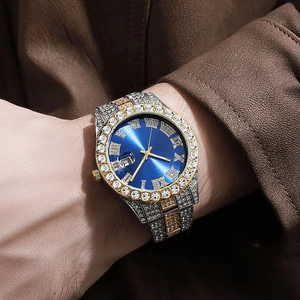 Close-up of a luxury men's watch with blue dial, roman numerals and iced-out diamond strap
