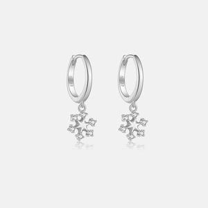 Macro detail of S925 sterling silver hoop earrings with sparkling snowflake pendants