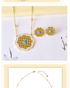 Detail of gold hollow flower necklace set with turquoise beads and sparkling crystals