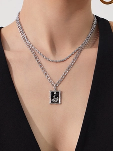 Close-up of double layer silver chain necklace with vintage rectangular cameo pendant