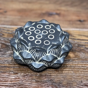 Macro detail of a stone-textured lotus seed pod silicone mold for tea ceremony decor