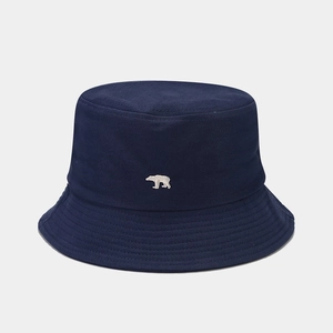 Detail of navy blue cotton bucket hat with white polar bear embroidery and reinforced brim