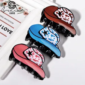 Three colorful cowboy hat hair claws in brown, blue and pink with star and cow print