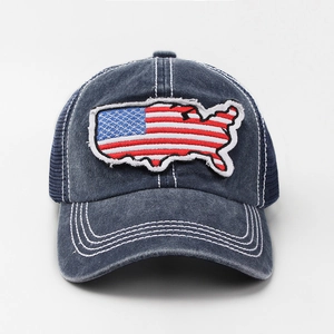 Detail of USA flag patch embroidery on navy blue distressed mesh trucker cap