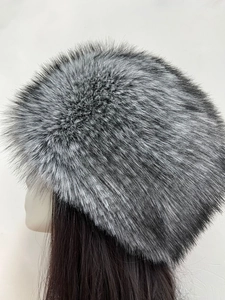 Detailed close-up of thick silver-gray faux fox fur texture on a Russian style winter hat