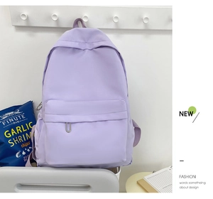 Macro view of light purple casual nylon backpack with front pocket on wooden hook