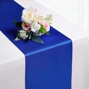 Close-up of royal blue satin table runner with silky sheen for elegant wedding decor