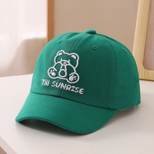 Close-up of green cotton baseball cap featuring embroidered cartoon bear and text logo