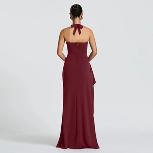Detail of burgundy backless halter gown featuring a delicate neck bow tie and zipper
