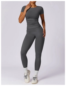 Detail of dark grey quick-dry compression yoga set showing slim fit and stretch fabric