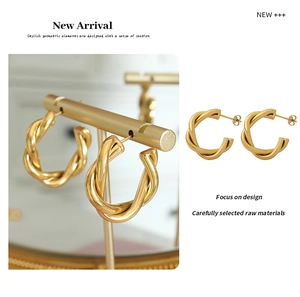 Close-up of 18K gold plated titanium steel C-shape twisted hoop earrings with butterfly back