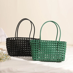 Minimalist hollow plastic woven shoulder bag in black and green for beach vacation style
