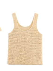 Detailed view of beige hollow crochet knit texture on a minimalist sleeveless vest