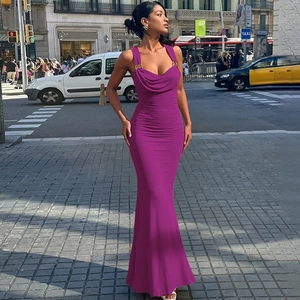Outdoor street view of a slim fit purple pleated maxi dress with elegant strap details