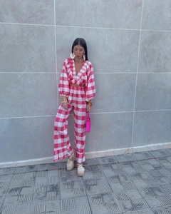 Detail of pink plaid V-neck cropped top and wide-leg trousers with ruffle trim accents