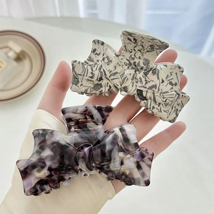 Pinces à cheveux en acétate en forme de nœud avec motifs marbre et écaille de tortue
