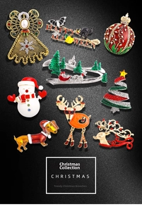 Flat lay of colorful enamel Christmas brooches with rhinestones on dark grey background