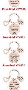 Detailed view of rose gold stainless steel keychains with heart charms and romantic engravings