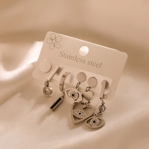 Detailed set of five stainless steel silver earrings with eye and heart charms on silk