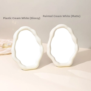 Close-up of cloud-shaped mirrors in glossy plastic and matte finishes for desktop decor
