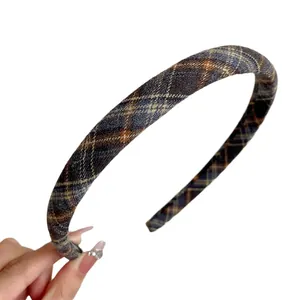 Classic blue and brown plaid fabric headband with a vintage preppy style on white background