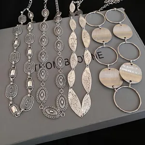 Vintage silver metal waist chain with oval floral engraving and leaf motifs