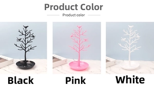 Three-color tree jewelry organizers with birds and round storage base on marble surface