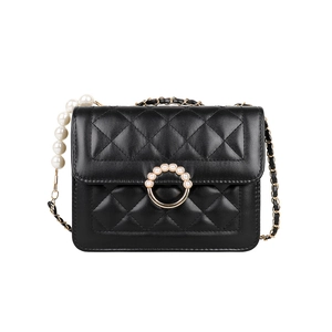 Elegant black quilted crossbody bag with pearl chain strap and gold ring closure