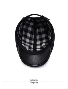 Detailed interior view showing black faux leather texture and grey plaid lining