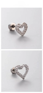Macro detail of hollow heart titanium steel stud earrings with shimmering white zircons
