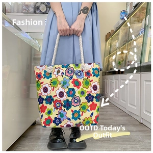Detail of floral canvas tote bag with thick cotton rope handles and vibrant pop art pattern
