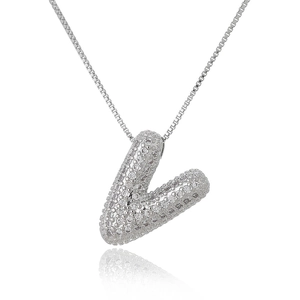 Macro shot of silver bubble letter V pendant with micro-pave cubic zirconia stones