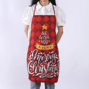 Detail of red plaid Christmas apron with Merry Christmas lettering on white background