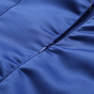 Close-up of royal blue invisible zipper on smooth plain weave fabric of the dress