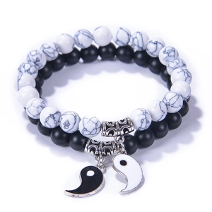 Tai Chi Yin Yang bracelets with matte black and white turquoise beads on white background