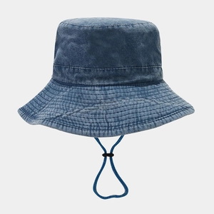 Detailed close-up of washed cotton denim sun hat with stitching and adjustable chin strap