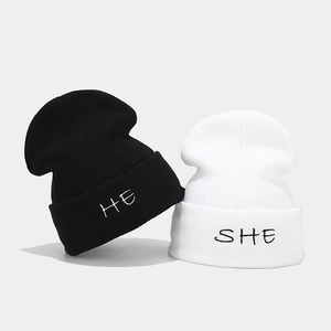 Couples' HE SHE embroidered knitted beanies in black and white for winter warmth
