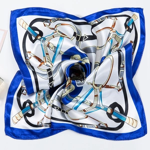 Detailed view of luxury square silk scarf with classic equestrian chain and belt prints