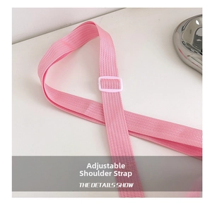 Close-up of the pink adjustable shoulder strap with white plastic buckle for kids backpack