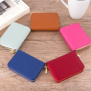 Litchi pattern leather zip card holders in five colors on a wooden table setup