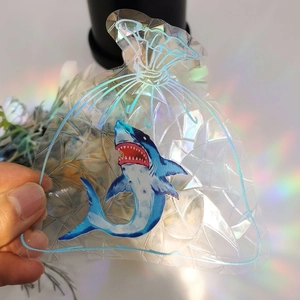 Close-up of rainbow prism suncatcher sticker with laser shark design and holographic finish