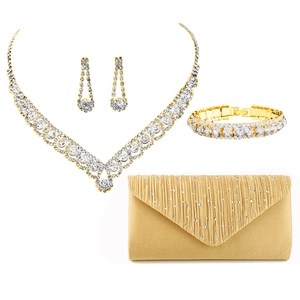 Golden bridal jewelry set with crystal necklace, earrings, bracelet and satin evening clutch