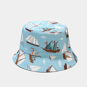 Detailed view of the light blue sun hat fabric featuring nautical sailboat prints
