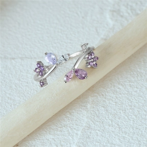 Macro view of S925 sterling silver flower ring with purple and clear zircon stones
